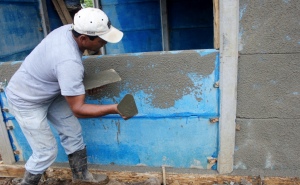 Fran applying cement mortar to the concrete panels.