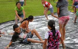 Slip and slide on a large plastic sheet is a favorite water day activity.